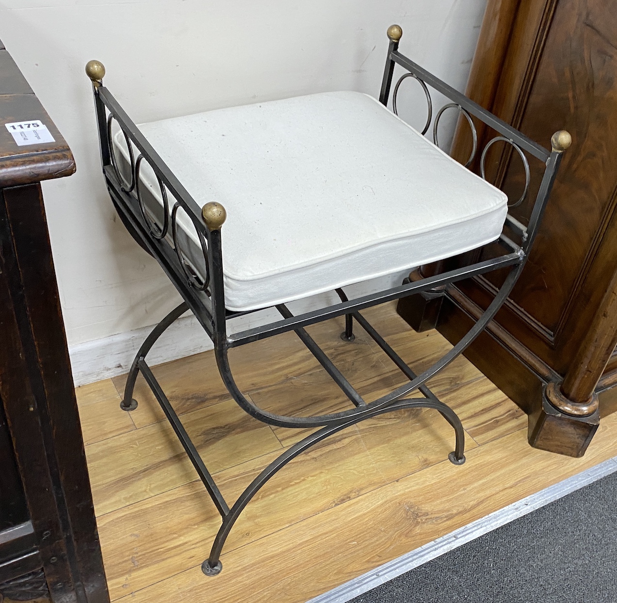 A pair of wrought iron ‘’X’’ framed stools, width 50cm, depth 42cm, height 66cm